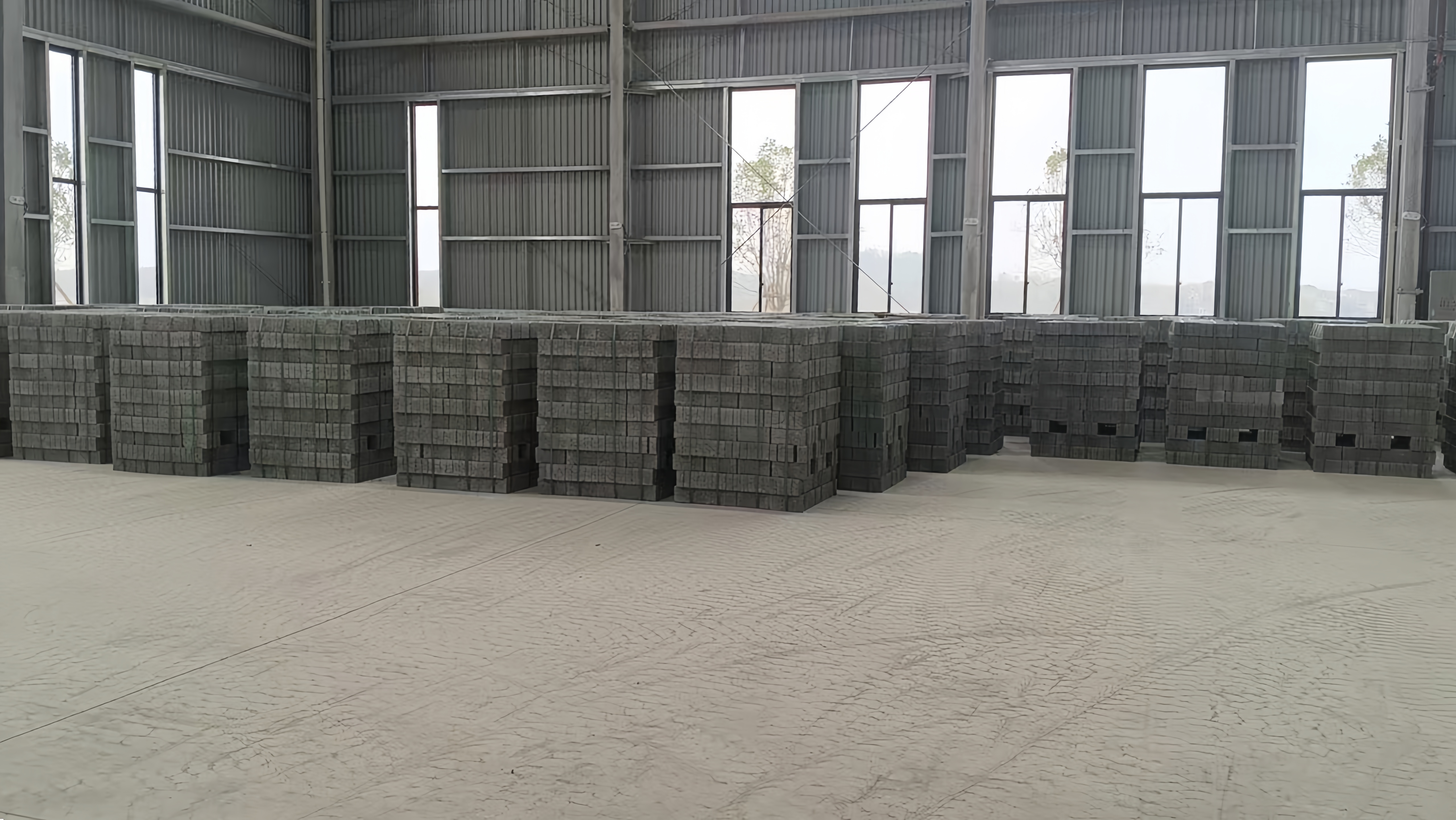 Products manufactured by the QS series concrete block machine, neatly stacked within the client’s workshop ~!phoenix_varIMG10!~