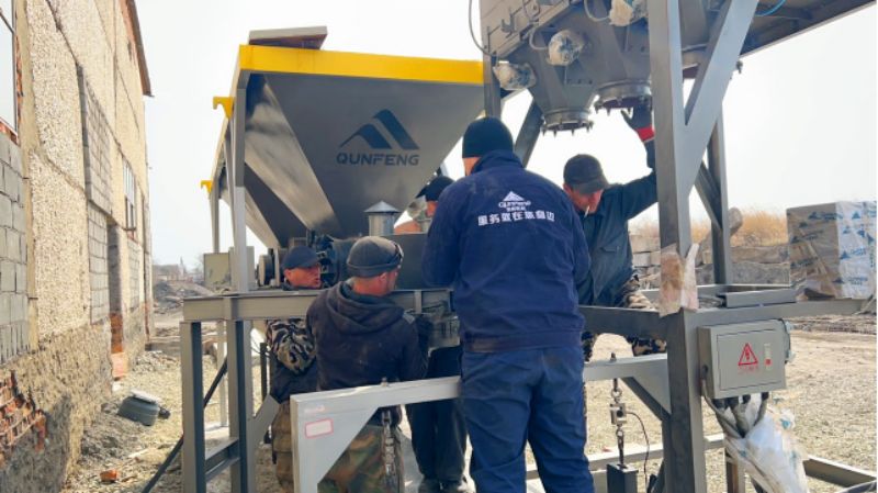 Equipe da Qunfeng ajustando a máquina dosadora de concreto